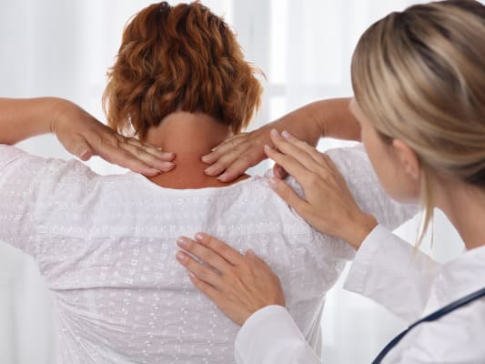 Physical therapist working with patient.