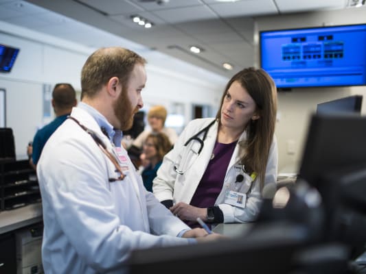 Residents discussing while charting