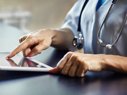 nurse entering medical information on computer