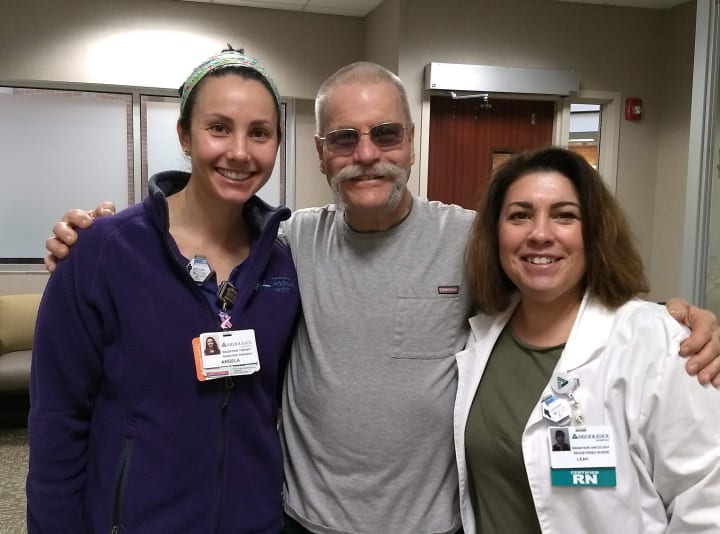 Jeffery with hospital employees Leah and Angela