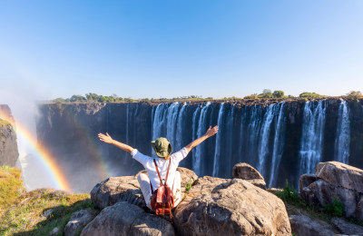 Woman sitting on the top of a rock enjoying the Victoria Falls_Zimbabwe_meinewelt-reisen.jpeg