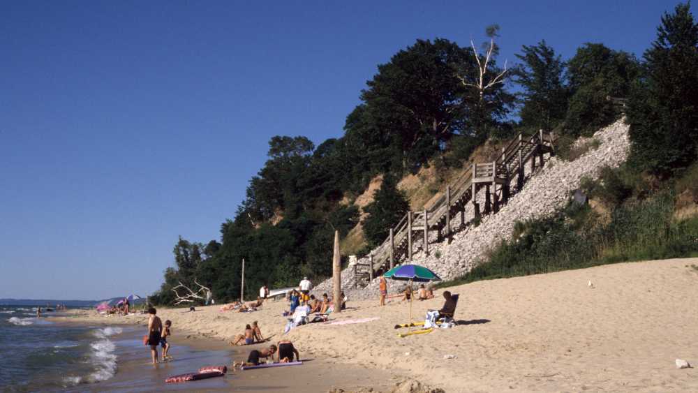 Beach goers on the sandy shore of Orchard Beach State Park Beach goers on the sandy shore of Orchard Beach State Park
