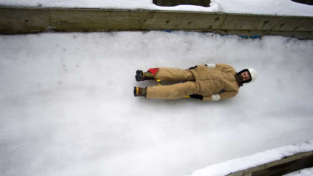 A person sledding on the luge at the Winter Sports Complex. A person sledding on the luge at the Winter Sports Complex.