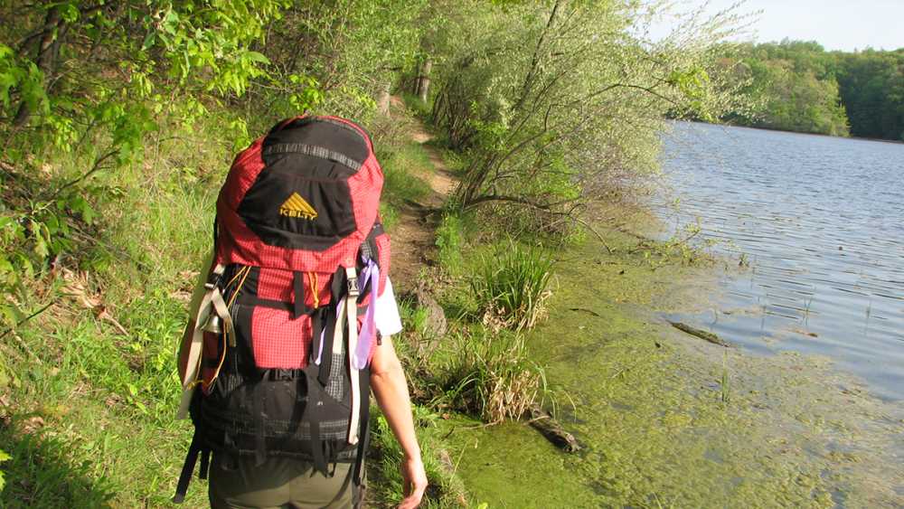 Backpacker on a trail at Holly Recreation Area. Backpacker on a trail at Holly Recreation Area.