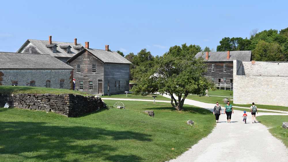 Women walk along a pathway at Fayette Townsite on a beautiful summer day. Women walk along a pathway at Fayette Townsite on a beautiful summer day.