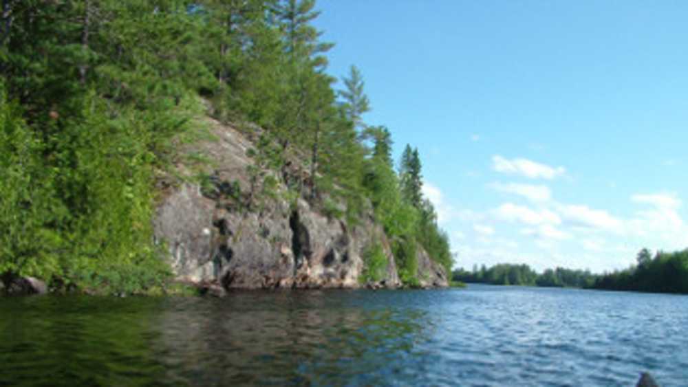 Craig Lake with a view of a rocky shoreline covered with trees. Craig Lake with a view of a rocky shoreline covered with trees.