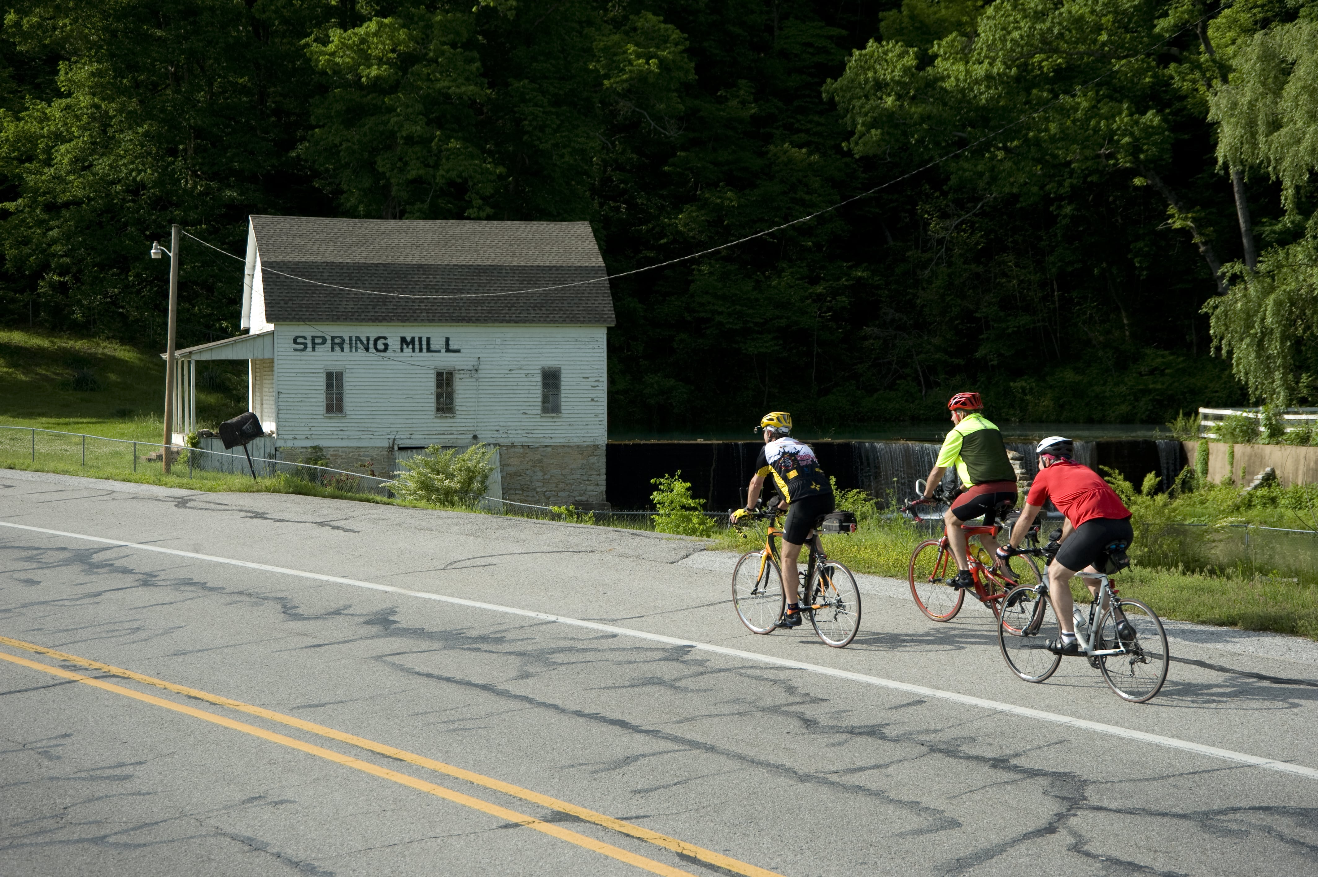 Cycling past the Spring Mill on the Batesville-Ozark Loop
