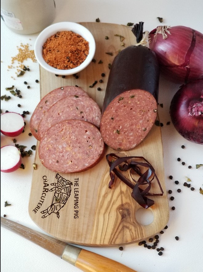 An image of summer sausage on the board
