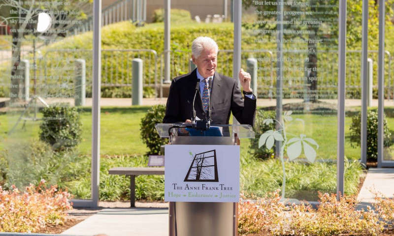 President Bill Clinton speaks at the dedication of The Anne Frank Tree installation at the Clinton Presidential Center
