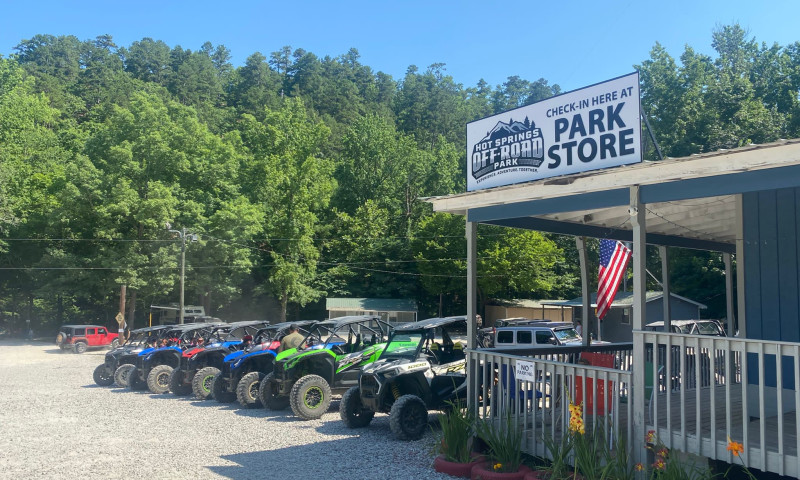 Brightly colored ATVs lined up in front of the park store.