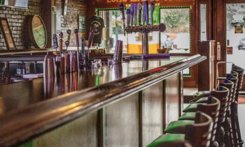 Traditional Irish bar with empty barstools.