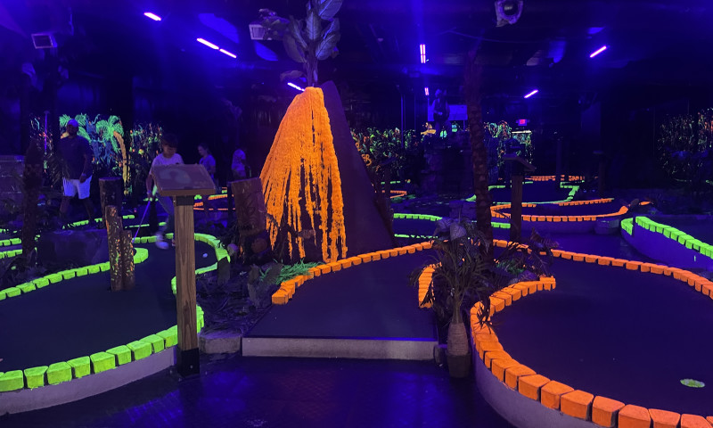 Mini-golf course lit up with blacklight.