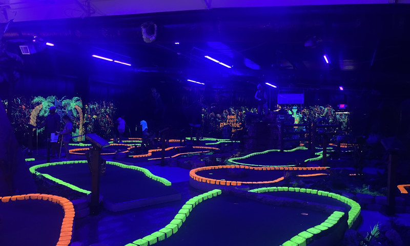 Mini-golf course lit by blacklights.