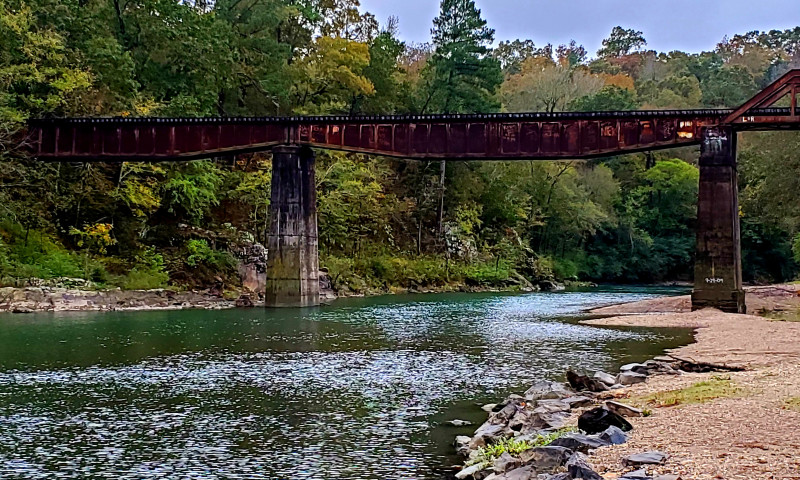 Tall train trestle spanning the Caddo River.