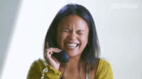 Woman laughing while taking a phone call