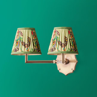 Double Insignia cordless wall fixture in antique brass
