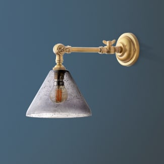 Double jointed wall fitting in antiqued brass