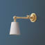 Double jointed wall fitting in antiqued brass