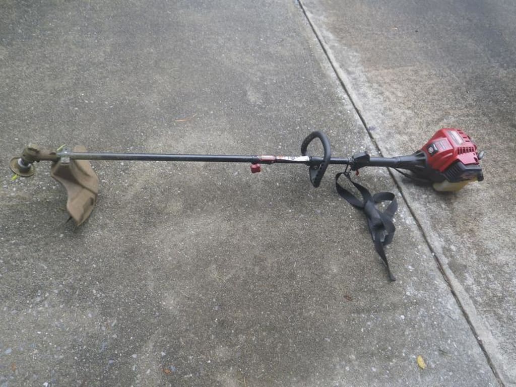 string trimmer with cutting head attached