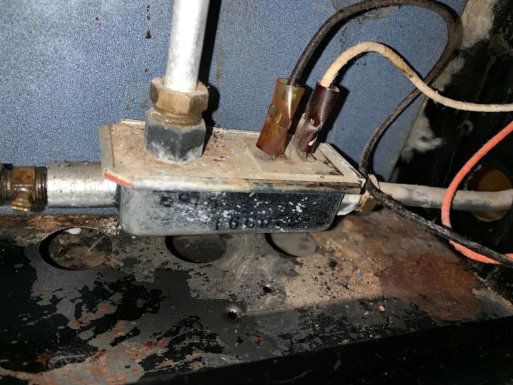 Gas safety valve serving gas to pilot, oven, and burners. Burners operate without thermocouple connected electrically. Gas safety valve serving gas to pilot, oven, and burners. Burners operate without thermocouple connected electrically.