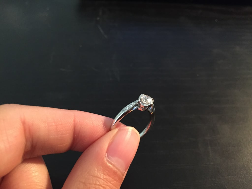 Oval diamond ring on hand