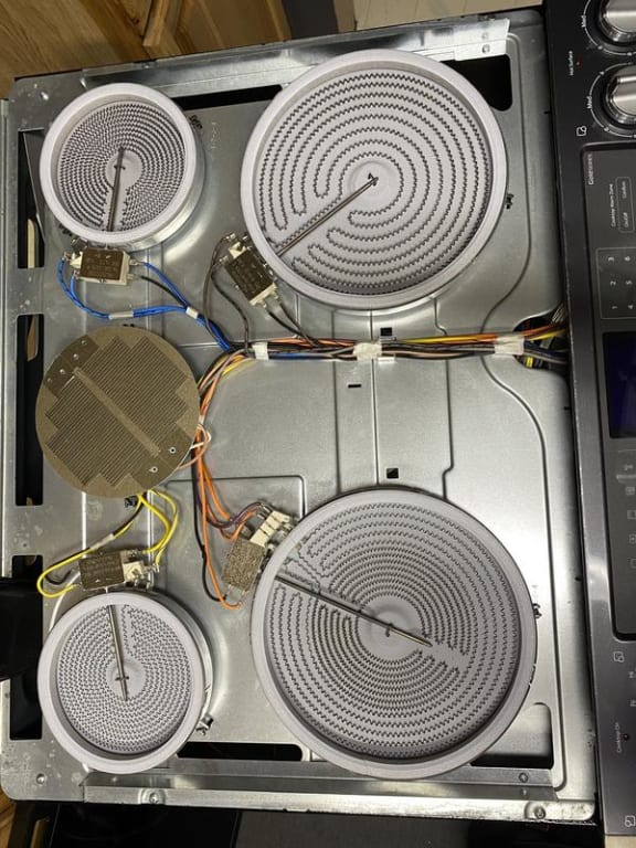 The stove top underneath the glass cleaned up. The stove top underneath the glass cleaned up.
