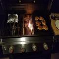Chicken thighs on griddle, burgers, and steamer bag with veggies