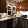 Renovated base cabinets with new downdraft vent behind new cooktop. Upper cabinets can now be refinished!
