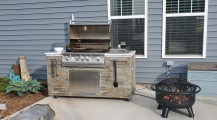 Lion grill before covered patio,