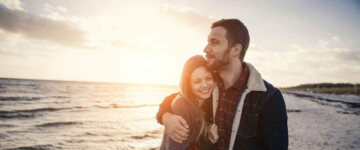 Photo of a lovely couple walking on the beach