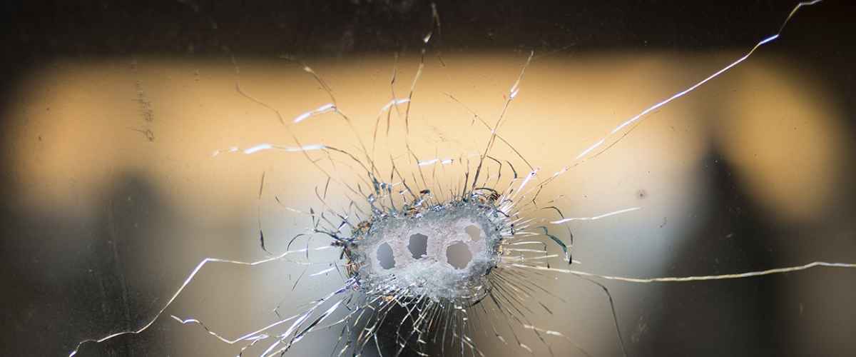 Bullet holes from a Kalashnikov rifle in front windshield