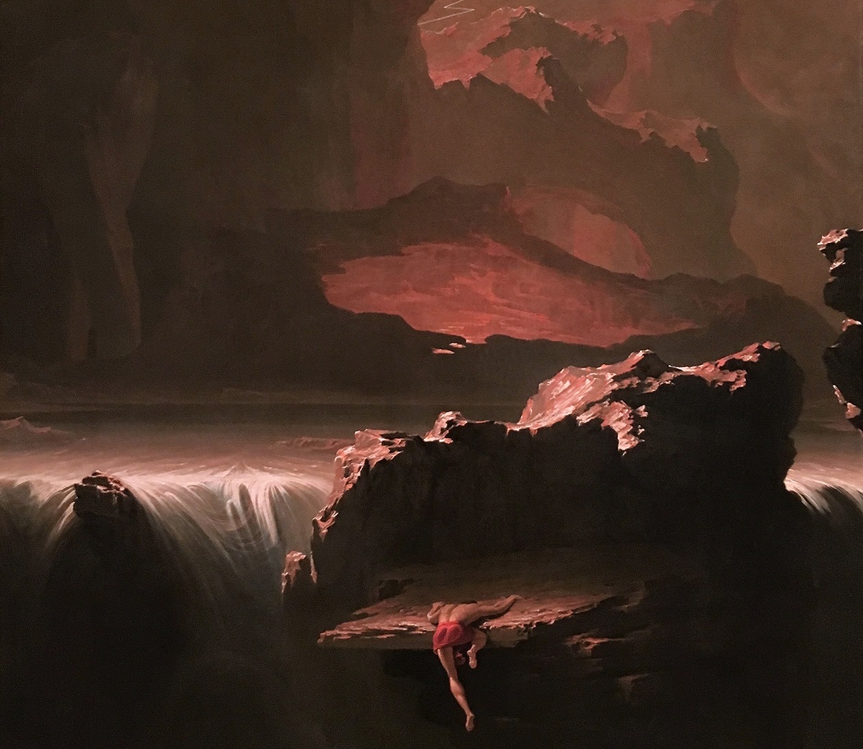 Romantic-era John Martin painting of a figure climbing an enormous mountain