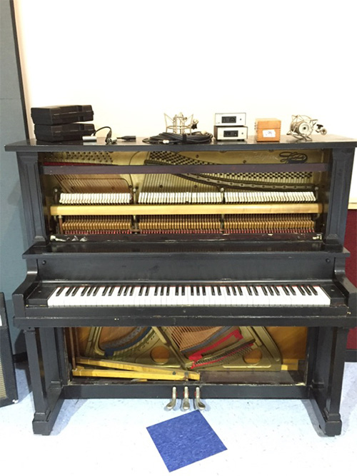 A vintage upright, fully exposed and ready for recording