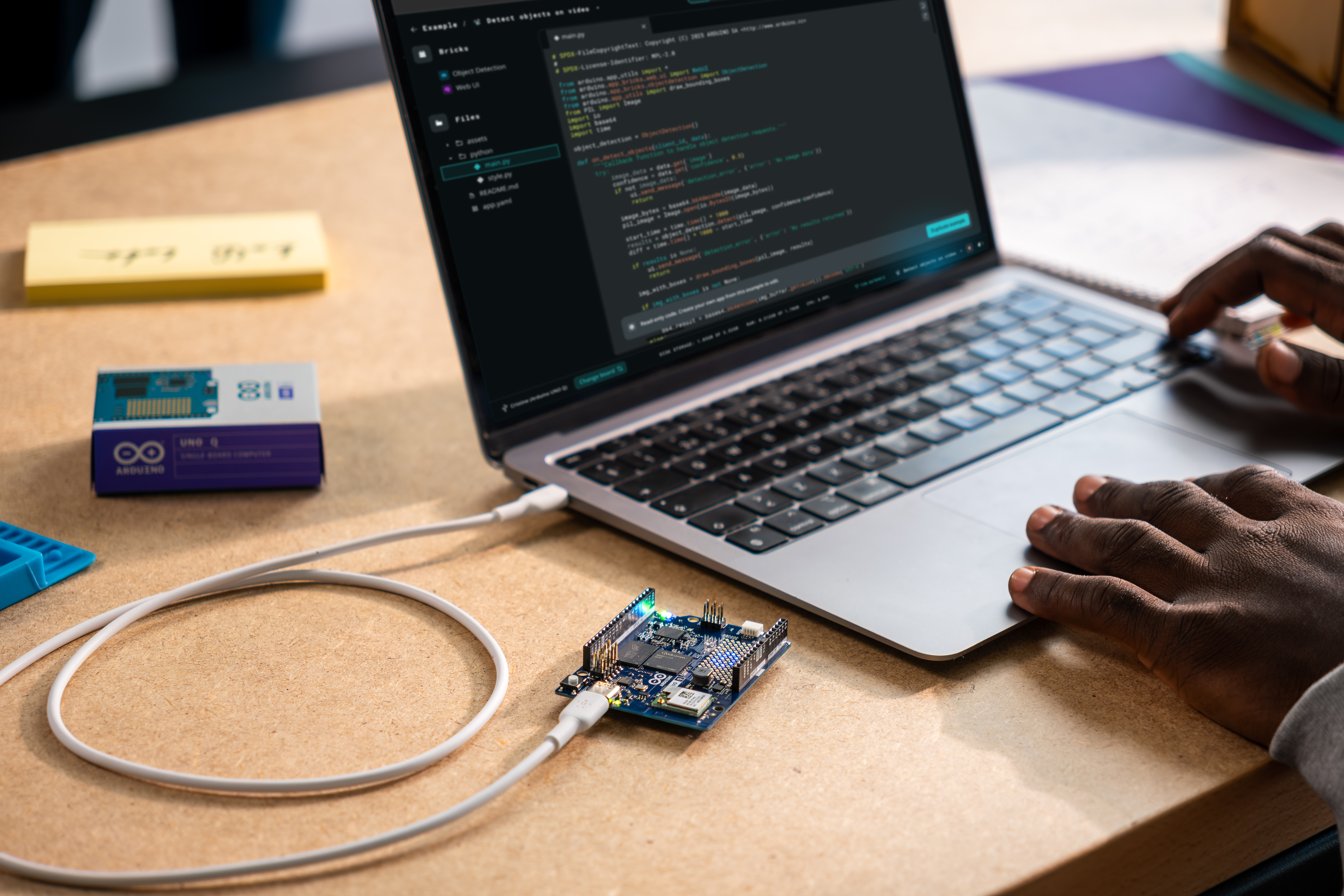 A person using the Arduino UNO Q and developing using Arduino App Lab