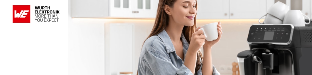 Woman enjoying hot drink next to home coffee machine