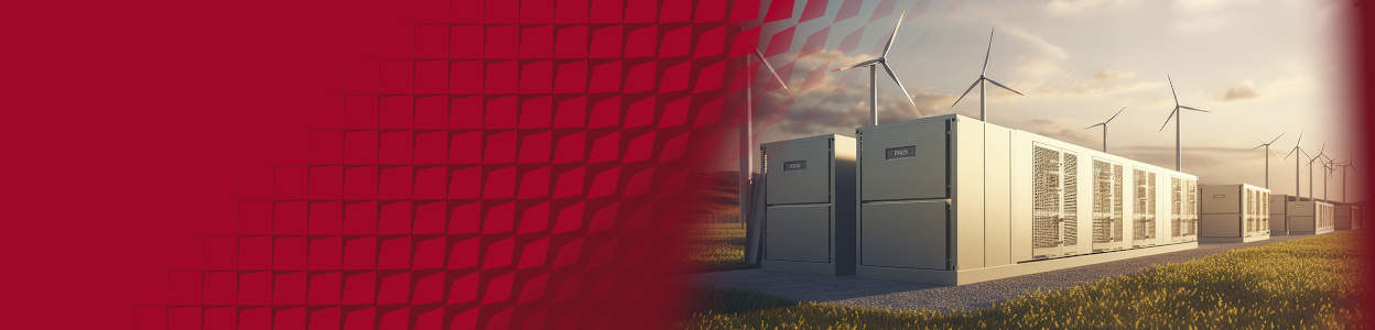 Large battery storage containers beside wind turbines storing renewable energy at a modern wind farm.