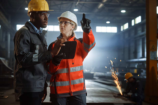 male and female engineers with PPE