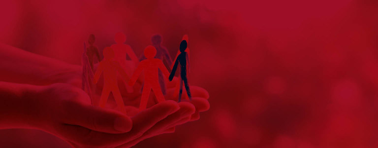 A person holding people made out of paper highlighting social responsibility