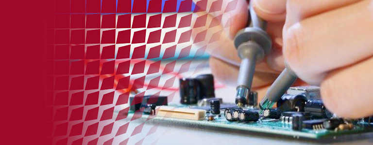 Engineer testing an electronic circuit board using oscilloscope probes while monitoring signal waveforms on a digital oscilloscope.