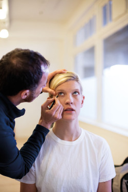Stylist Noel Plemmons applies makeup to conceal the gender of lead actor Allison Tigard.