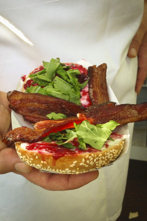 Tastebud's bacon and raspberry jam bagel with cream cheese and arugula