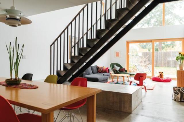 The home is a study in clean design, from the folded-steel stairs to the midcentury furniture to the exterior, scaled to echo the adjacent houses without mimicking them.