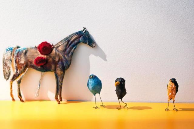 A tin horse and bird sculptures from Dou Dou Studio contrast with the home’s minimalist aesthetic.