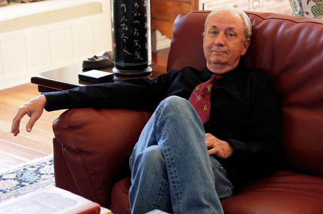 Michael Nesmith sitting on a couch.