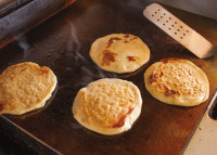Pupusas sizzling at Pupuseria Factory