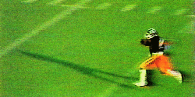 Darryl Baines running on a football field
