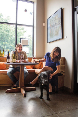 Thomas and Kate Monroe with their dog, Butch Cassidy, in Southeast Wine Collective’s tasting room