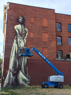 A new mural going up at SW Washington and 11th Ave by Faith47.
