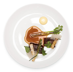Two meats (rib eye and short rib), an onion collection, and a pool of caramelized mussel jus at Castagna