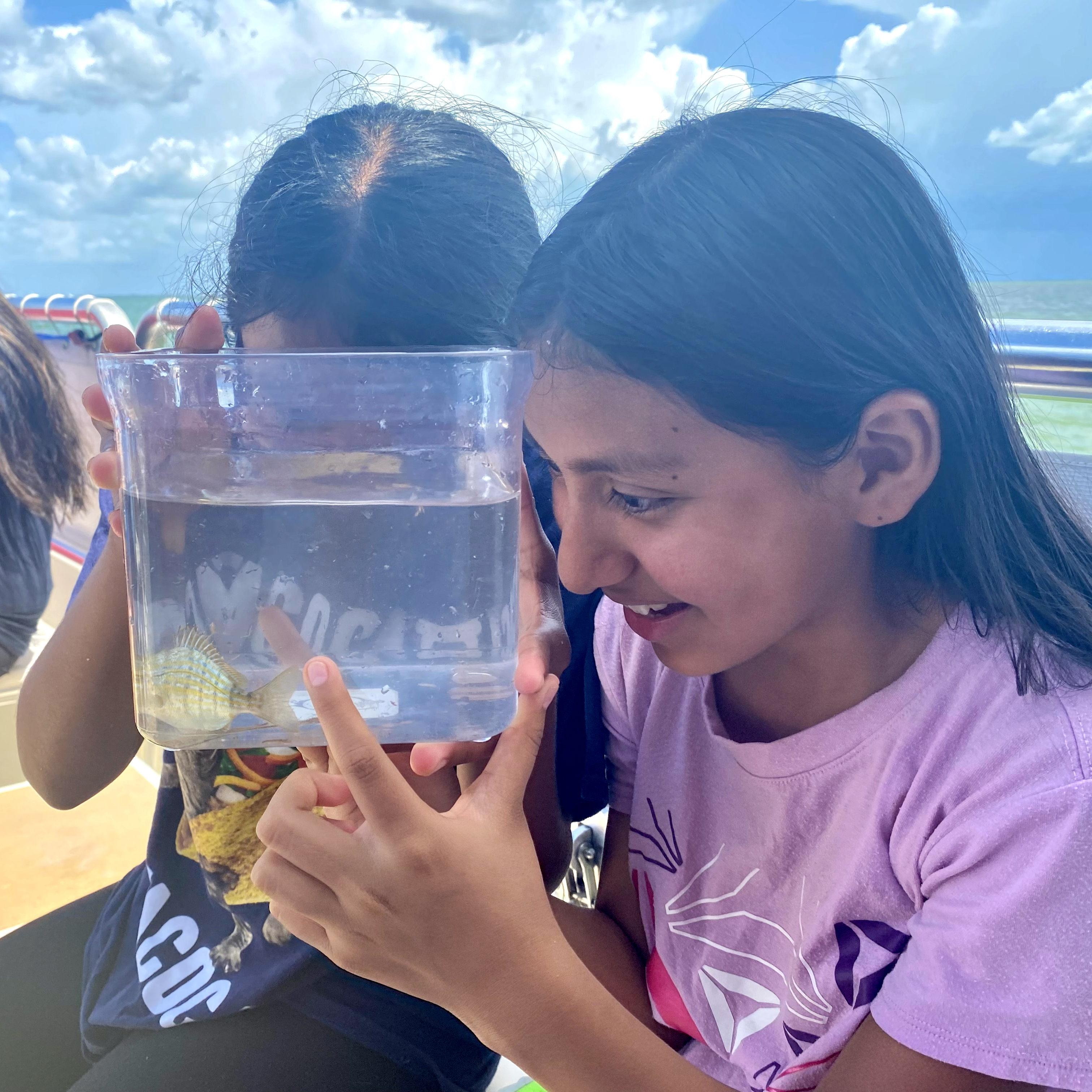 Image of two girls looking at fish
